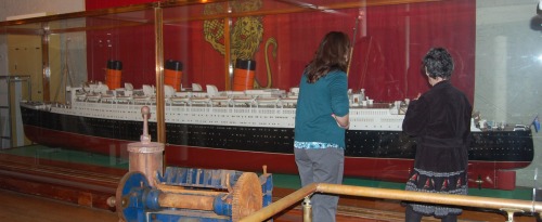 The model of the Queen Mary being admired by the South Street Seaport Museum's Collection Manager, MaryElizabeth Nora, and by my wife, Jane Bevans